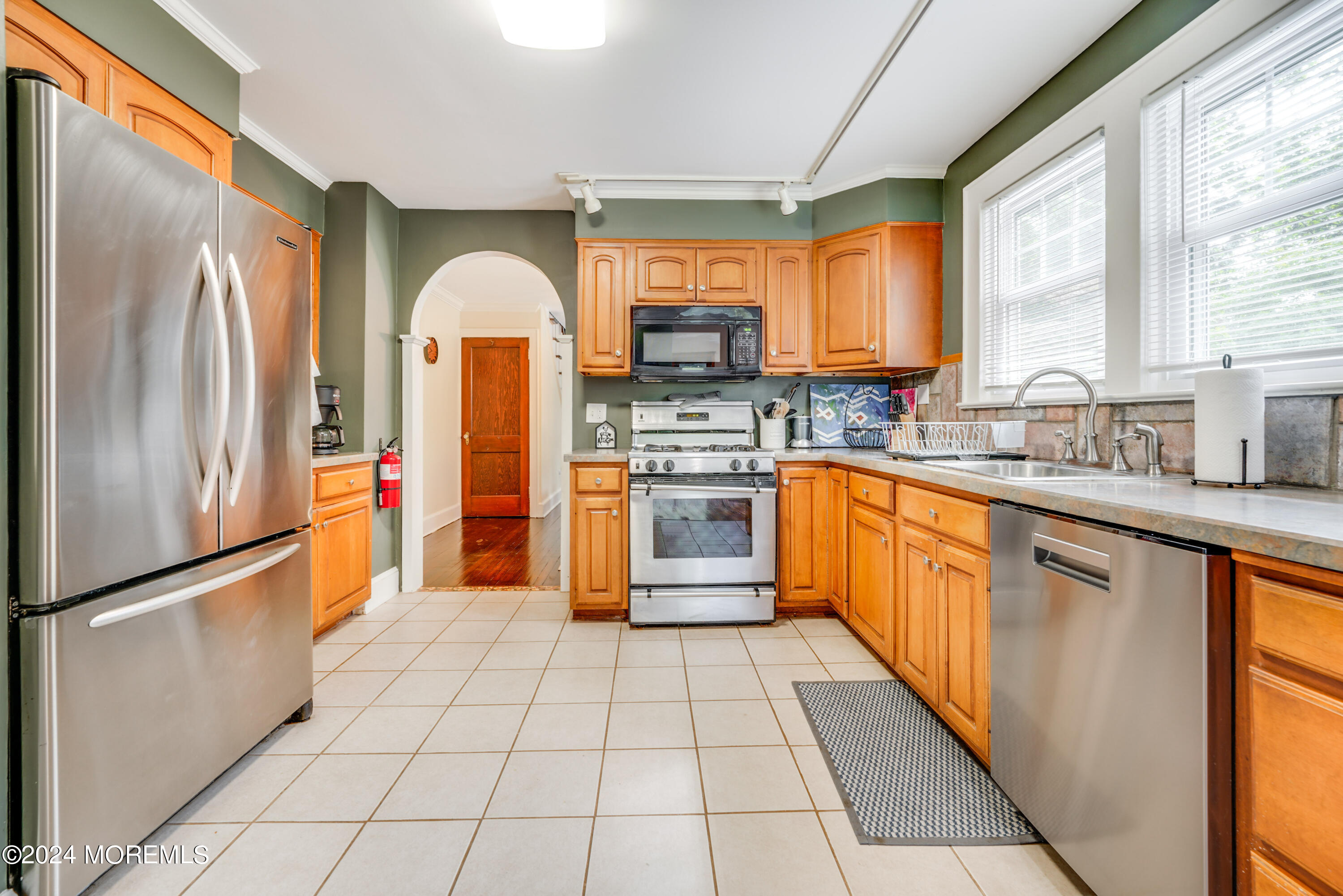 500 Locust Point Road Rumson, NJ 07760 - Photo 6 of 48 a kitchen with stainless steel appliances granite countertop a refrigerator a sink a stove with granite countertops and windows