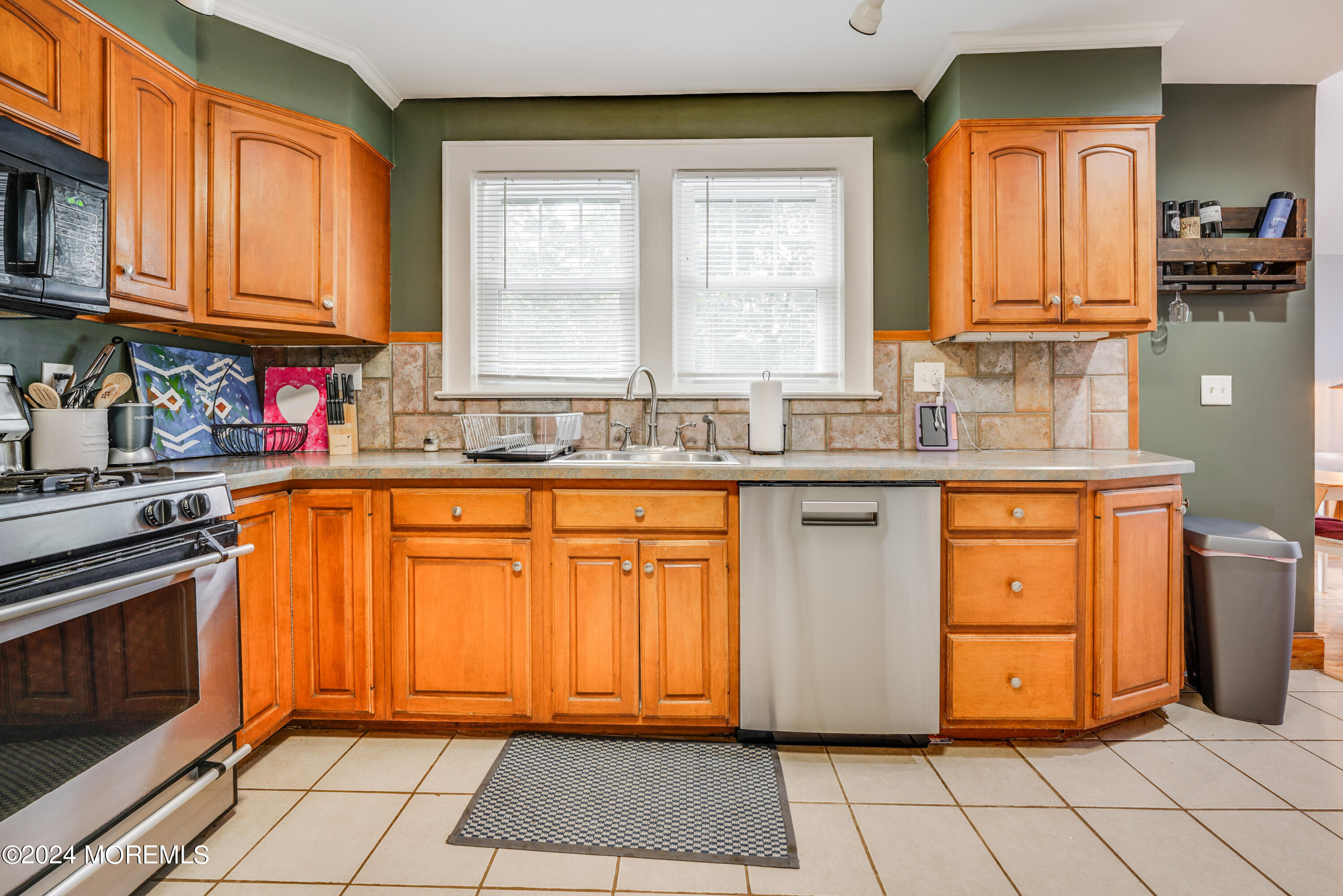 500 Locust Point Road Rumson, NJ 07760 - Photo 8 of 48 a kitchen with stainless steel appliances granite countertop a stove a sink and a microwave