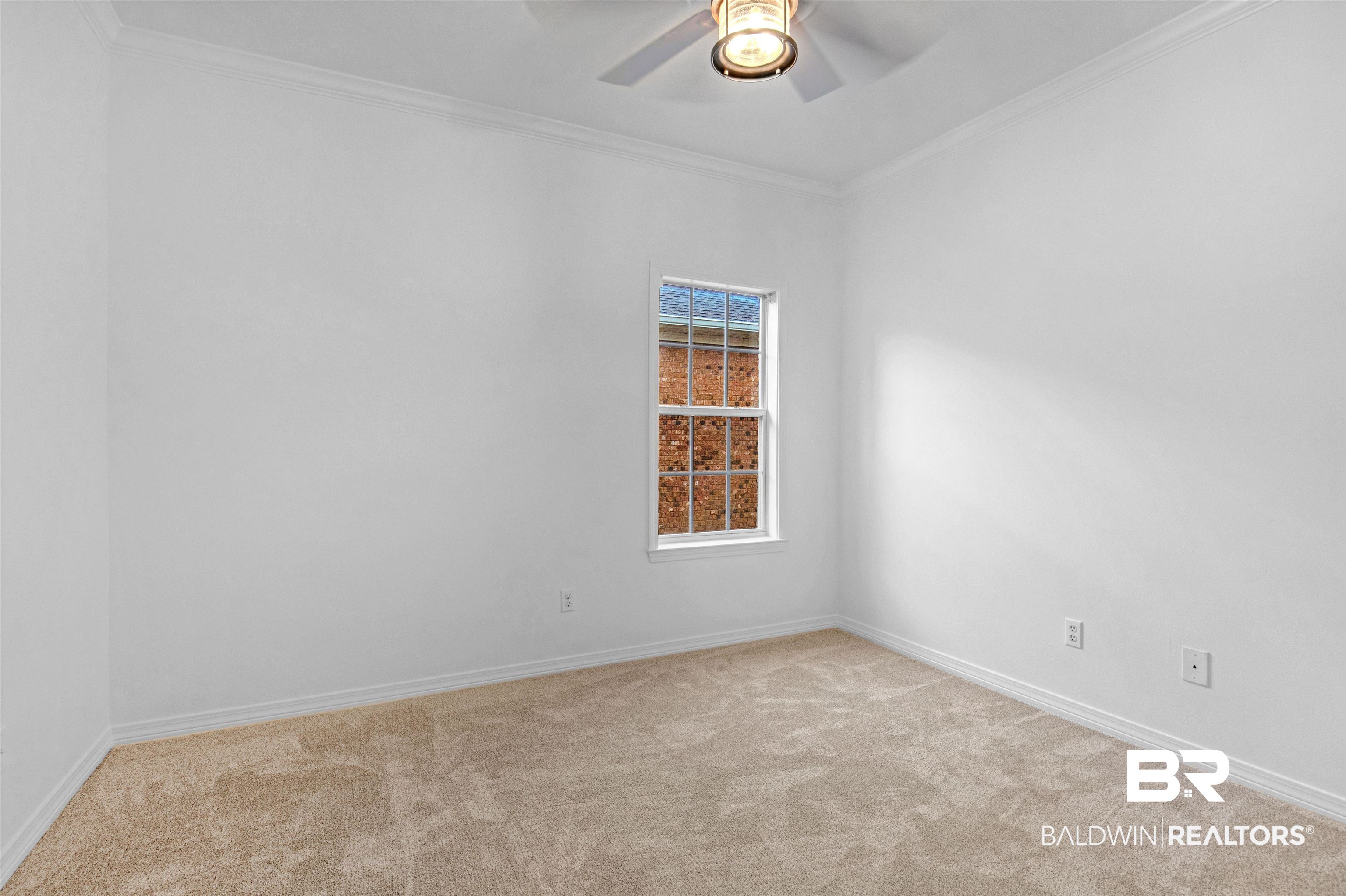 1007 Linlen Avenue Mobile, AL 36609 - Photo 11 of 21 Empty room featuring ornamental molding, light colored carpet, and ceiling fan