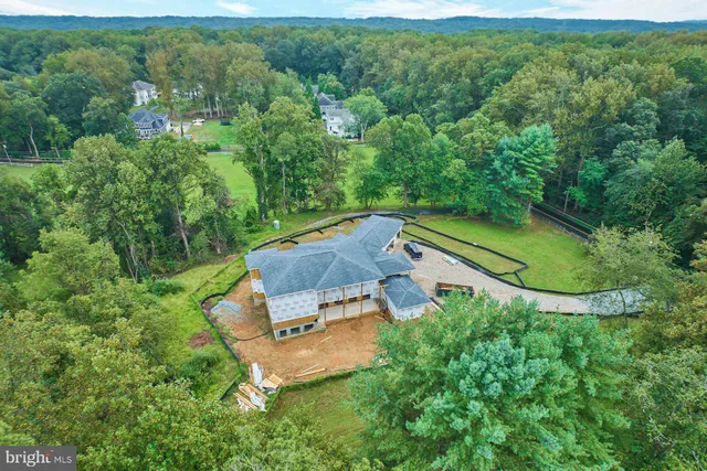 an aerial view of a house with pool patio and outdoor seating