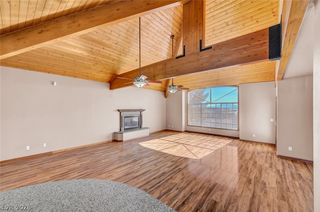 640 North Racetrack Road Henderson, NV 89015 - Photo 19 of 65 A spacious living area featuring striking wood beam ceilings and a warm, inviting fireplace.