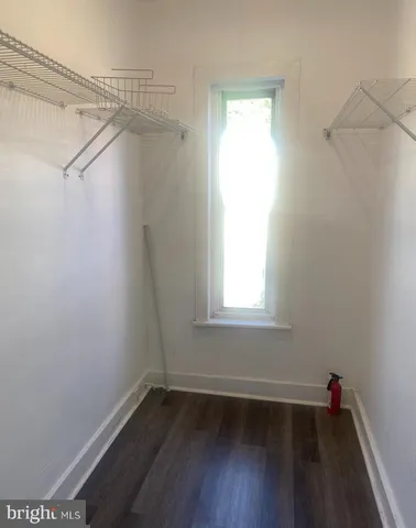 a view of a room with wooden floor and fan