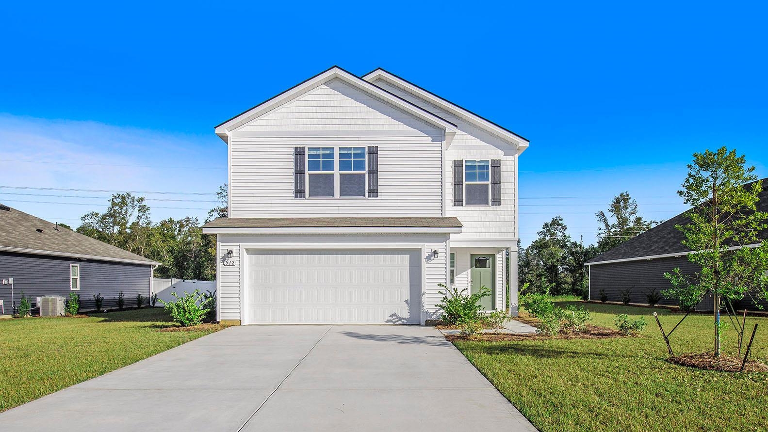 157 Homestead Way Myrtle Beach, SC 29588 - Photo 1 of 23 View of front of property with a front yard, an attached garage, and concrete driveway