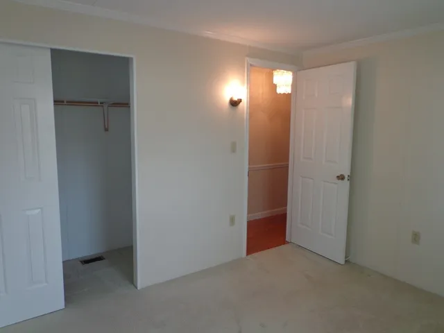 a view of an empty room with a bathroom