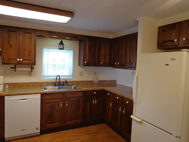 a kitchen with a sink a stove and cabinets