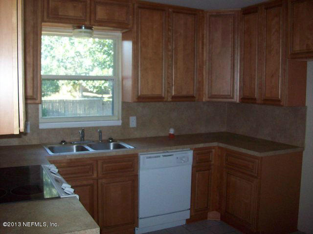 3750 Heath Road Jacksonville, FL 32277 - Photo 4 of 12 a kitchen with sink a window and cabinets