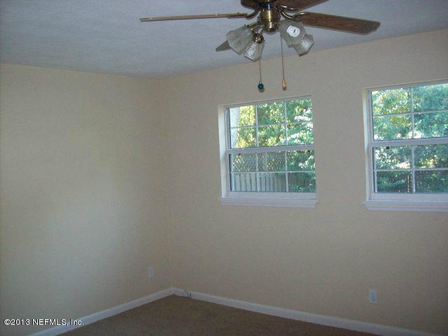 3750 Heath Road Jacksonville, FL 32277 - Photo 9 of 12 an empty room with a window and a fan
