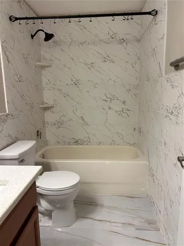 a bathroom with a toilet and a bathtub