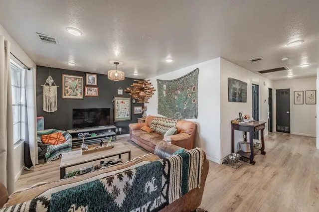 a bedroom with furniture and a flat screen tv