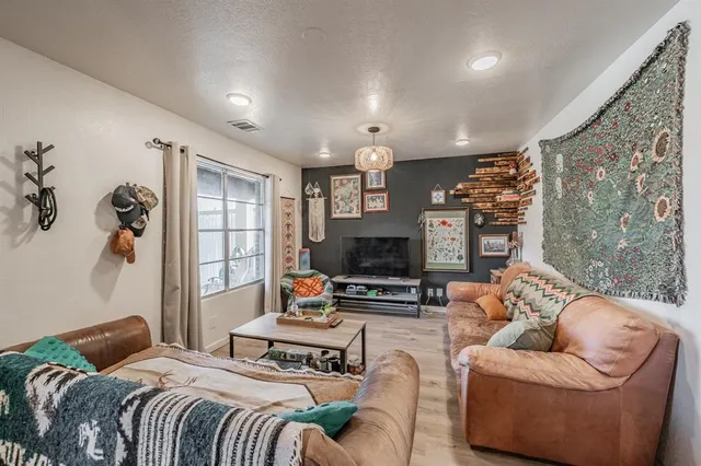 a bedroom with furniture a bed and a flat screen tv