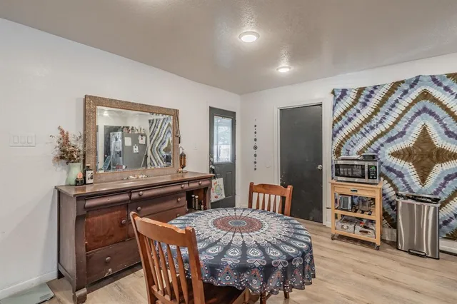 a dining room with furniture and wooden floor