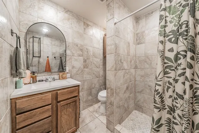 a bathroom with a double vanity sink toilet and a mirror