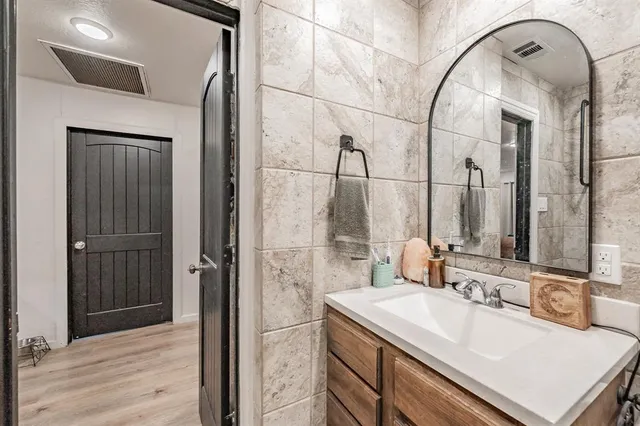 a bathroom with a sink and a mirror