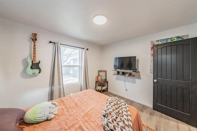 a bedroom with a bed and a flat screen tv