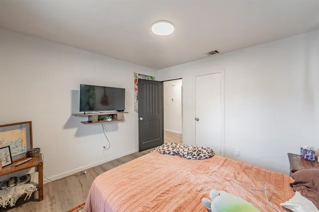 a bedroom with a bed and a flat screen tv