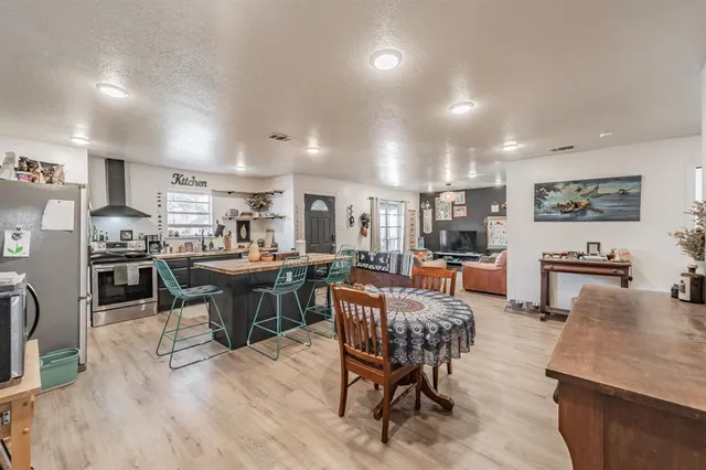 a living room with lots of furniture and kitchen view