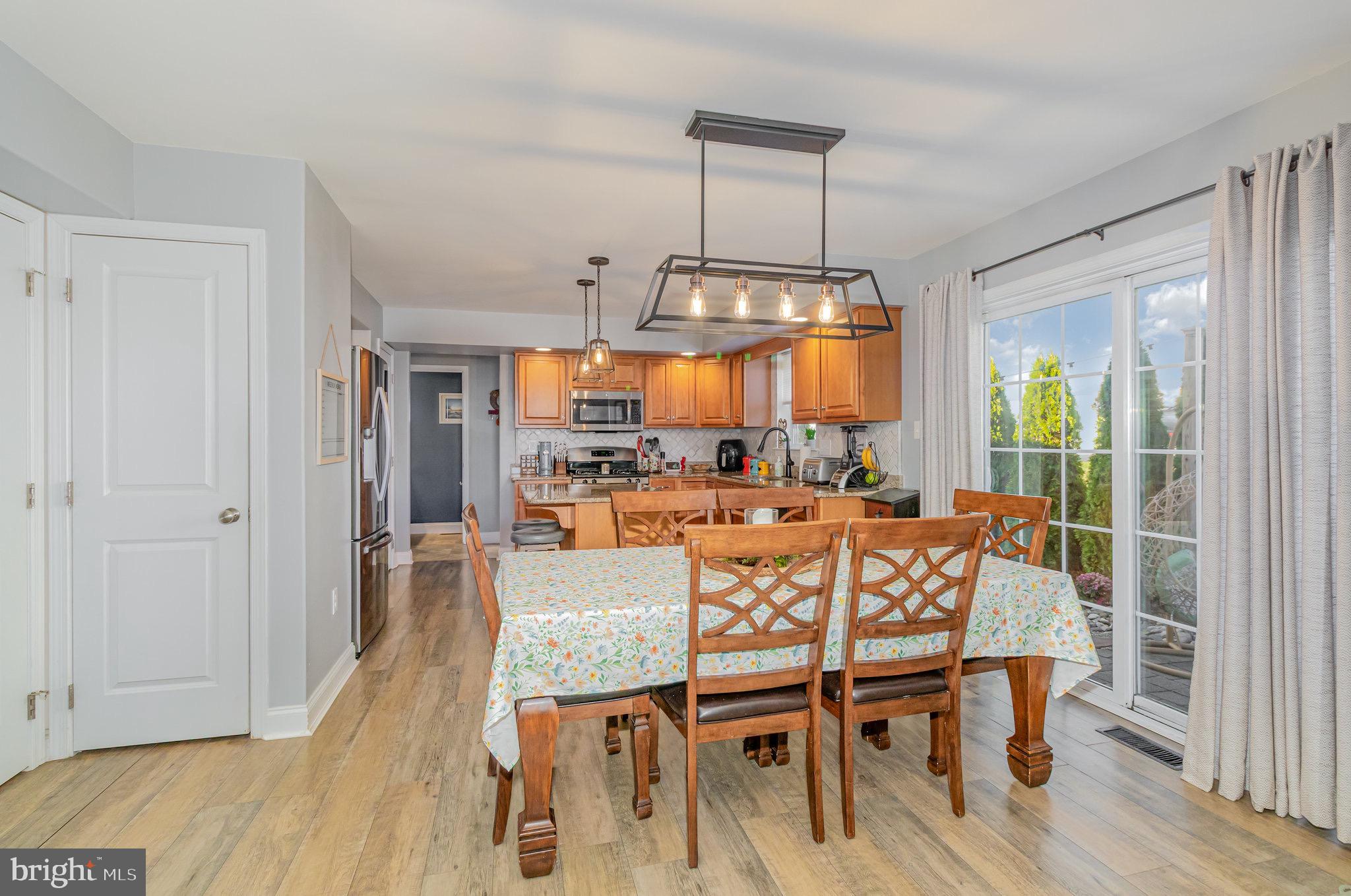 1799 Campus Road Elizabethtown, PA 17022 - Photo 11 of 28 a dining room with furniture a chandelier and wooden floor