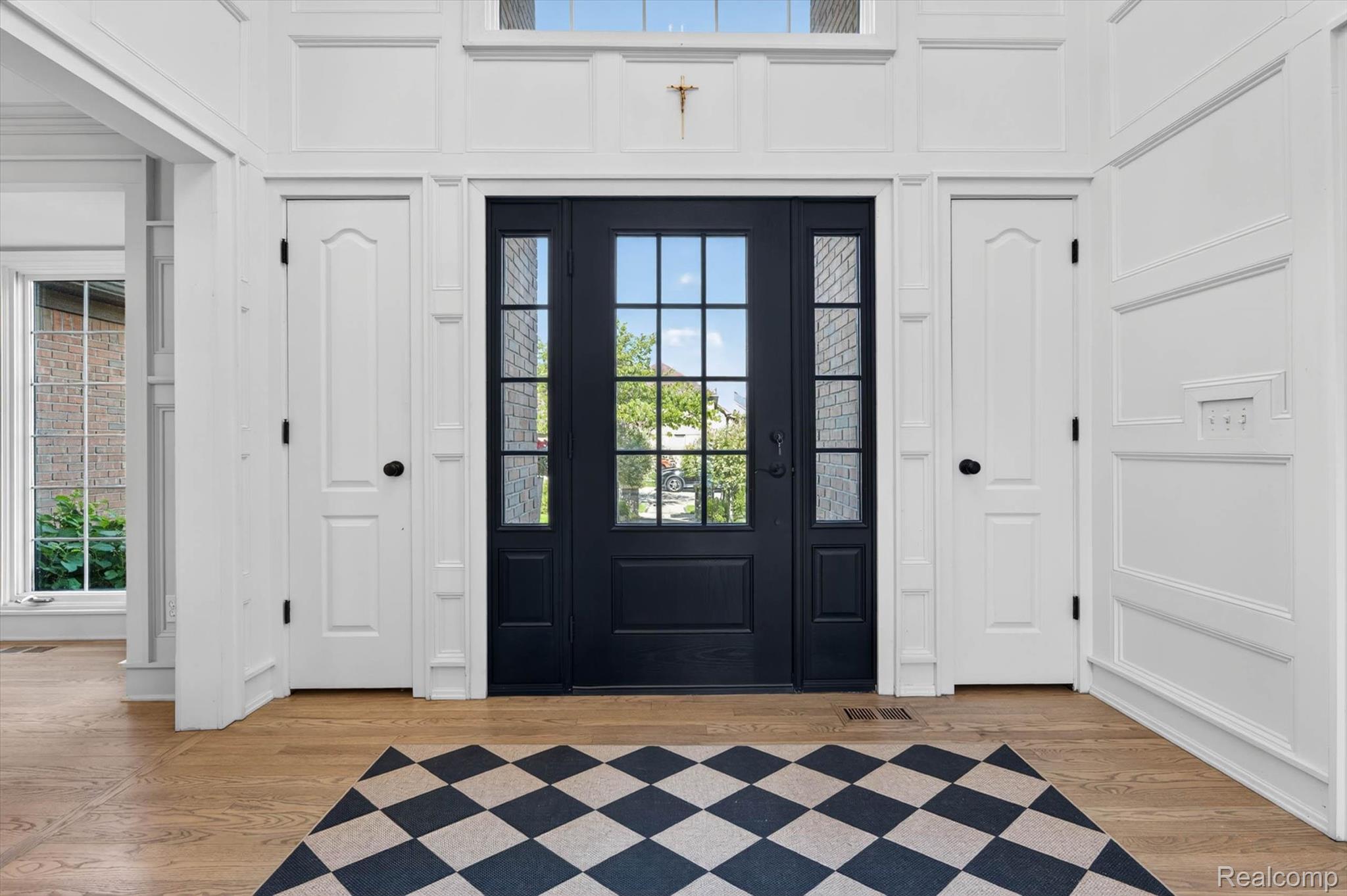 371 Lone Pine Circle Rochester, MI 48307 - Photo 6 of 59 Entryway featuring a dark paneled door with glass inserts, sidelight windows, transom windows, and white wainscoting