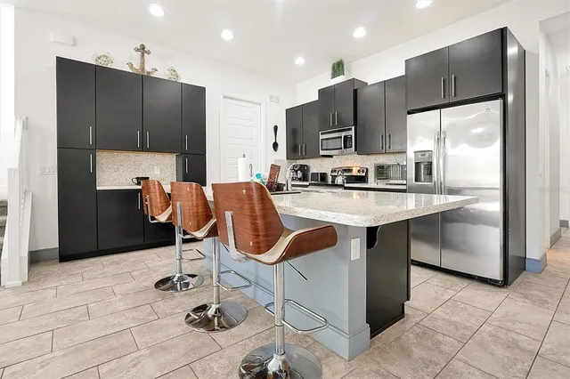 a bedroom with a bed a fireplace and a painting on the wall