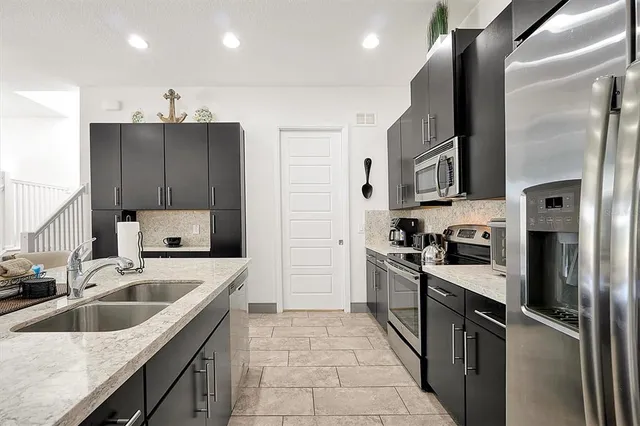 a bedroom with a bed next to a window