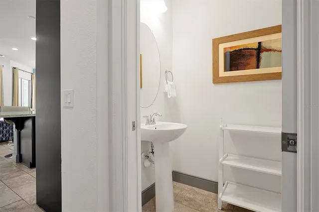 a bedroom with a bed and a lamp on dresser