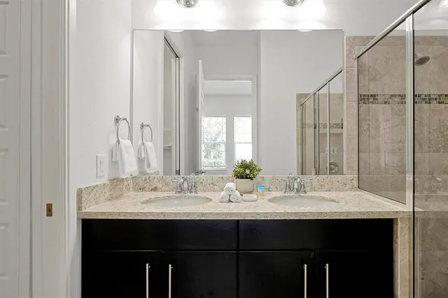 a bedroom with a bed and a lamp with the wooden floor