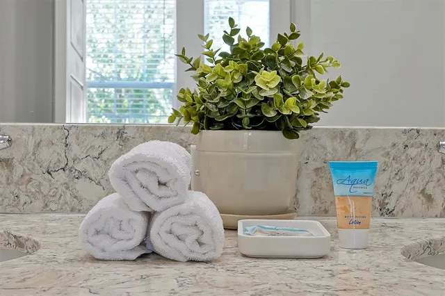 a bathroom with a granite countertop sink a toilet and bathtub