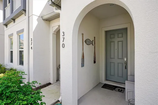 a living room with furniture kitchen view and a flat screen tv