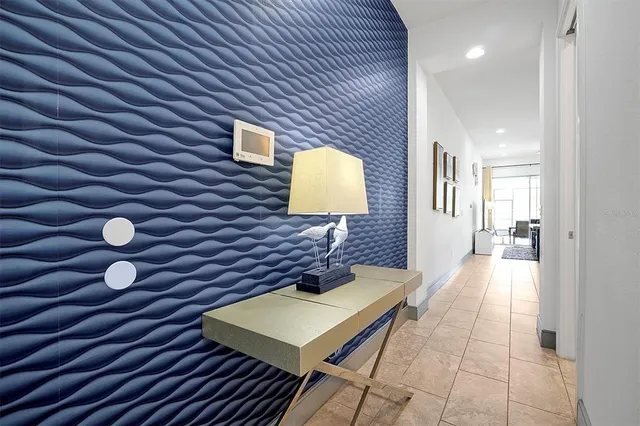 a living room with furniture a flat screen tv and a large window