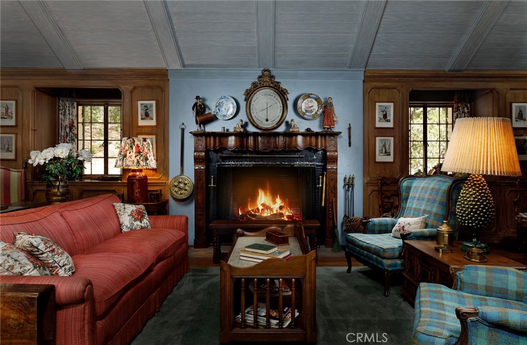 28641 North Shore Road Lake Arrowhead, CA 92352 - Photo 11 of 75 a living room with furniture a fireplace a rug and a window