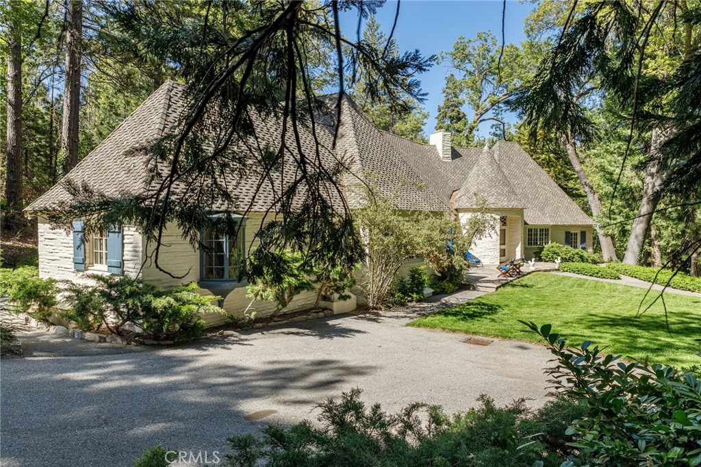 28641 North Shore Road Lake Arrowhead, CA 92352 - Photo 20 of 75 a front view of a house with a garden and tree