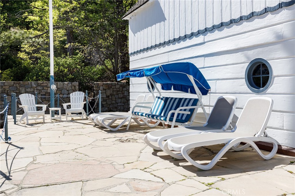 28641 North Shore Road Lake Arrowhead, CA 92352 - Photo 46 of 75 a view of a chairs and table in the patio
