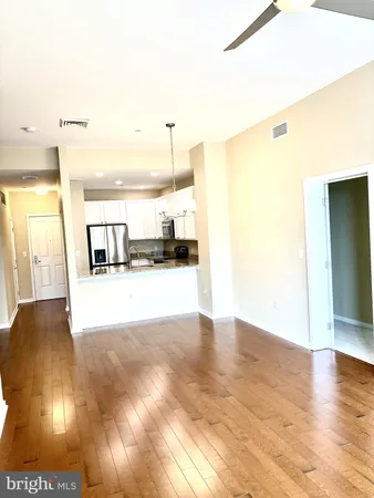 a kitchen with granite countertop a refrigerator and a stove top oven