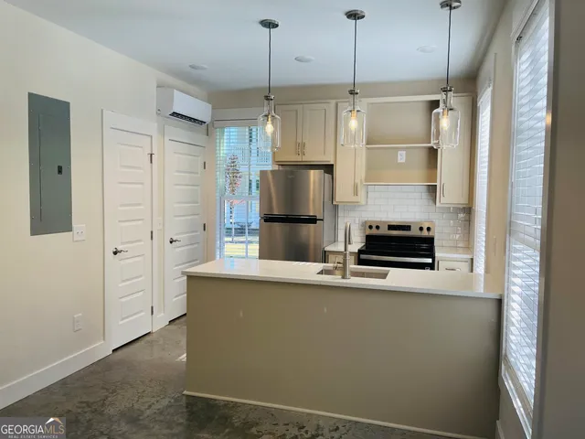a kitchen with stainless steel appliances a refrigerator and a stove
