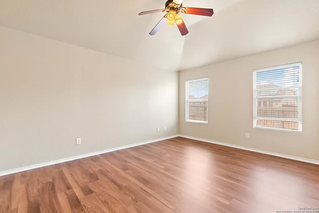 a view of a room with wooden floor and window