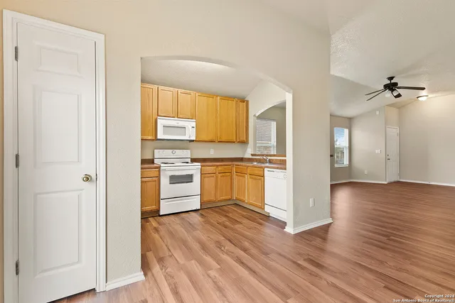 a kitchen with a refrigerator and a stove top oven