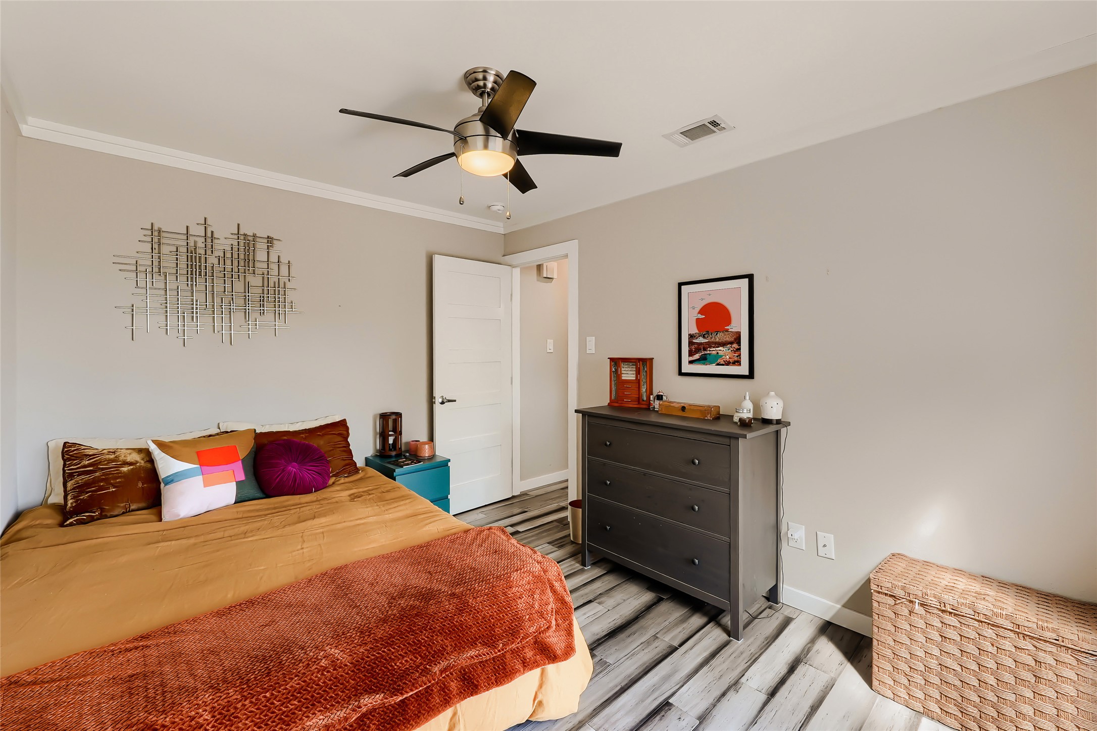 5707 Tracy Lynn Lane, Unit A Austin, TX 78721 - Photo 19 of 33 Bedroom featuring light wood finished floors, a ceiling fan, and crown molding