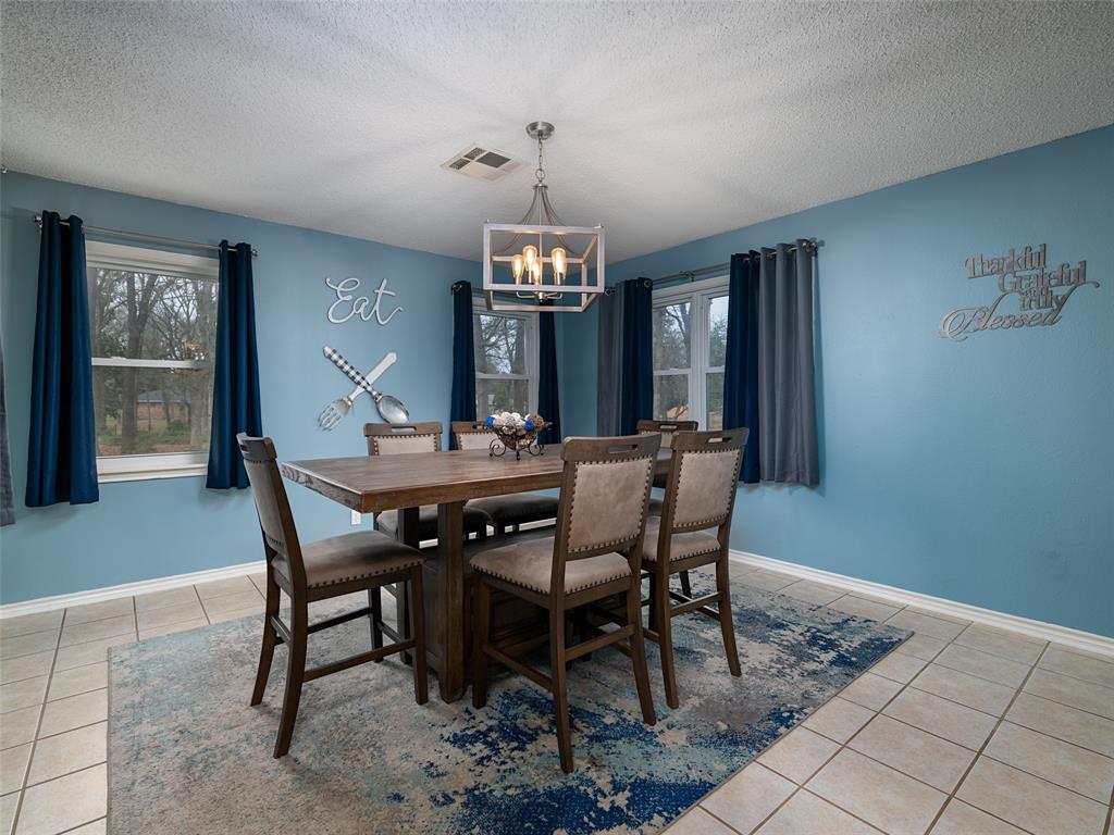 9663 Matise Street Tyler, TX 75706 - Photo 8 of 15 a view of a dining room with furniture window and wooden floor