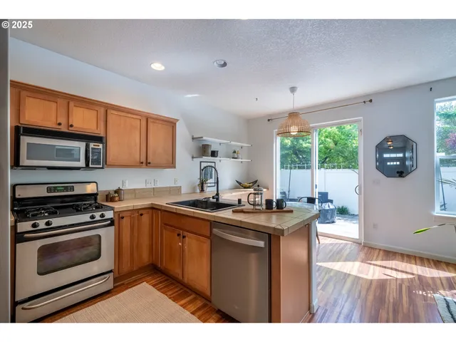 a kitchen with a stove a sink and a microwave