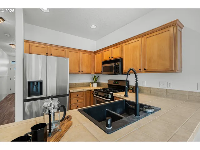 a kitchen with a sink appliances and cabinets