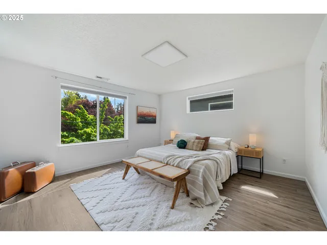 a bed room with a bed window and a chair