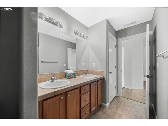a bathroom with a sink a mirror and a vanity