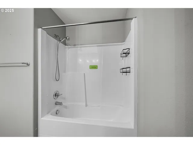 a bathroom with a shower and a bath tub