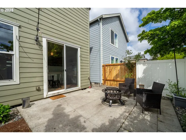 a backyard of a house with table and chairs