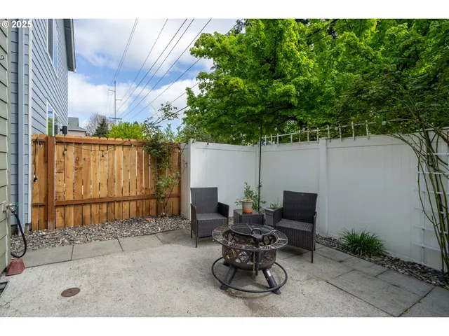 a backyard of a house with table and chairs