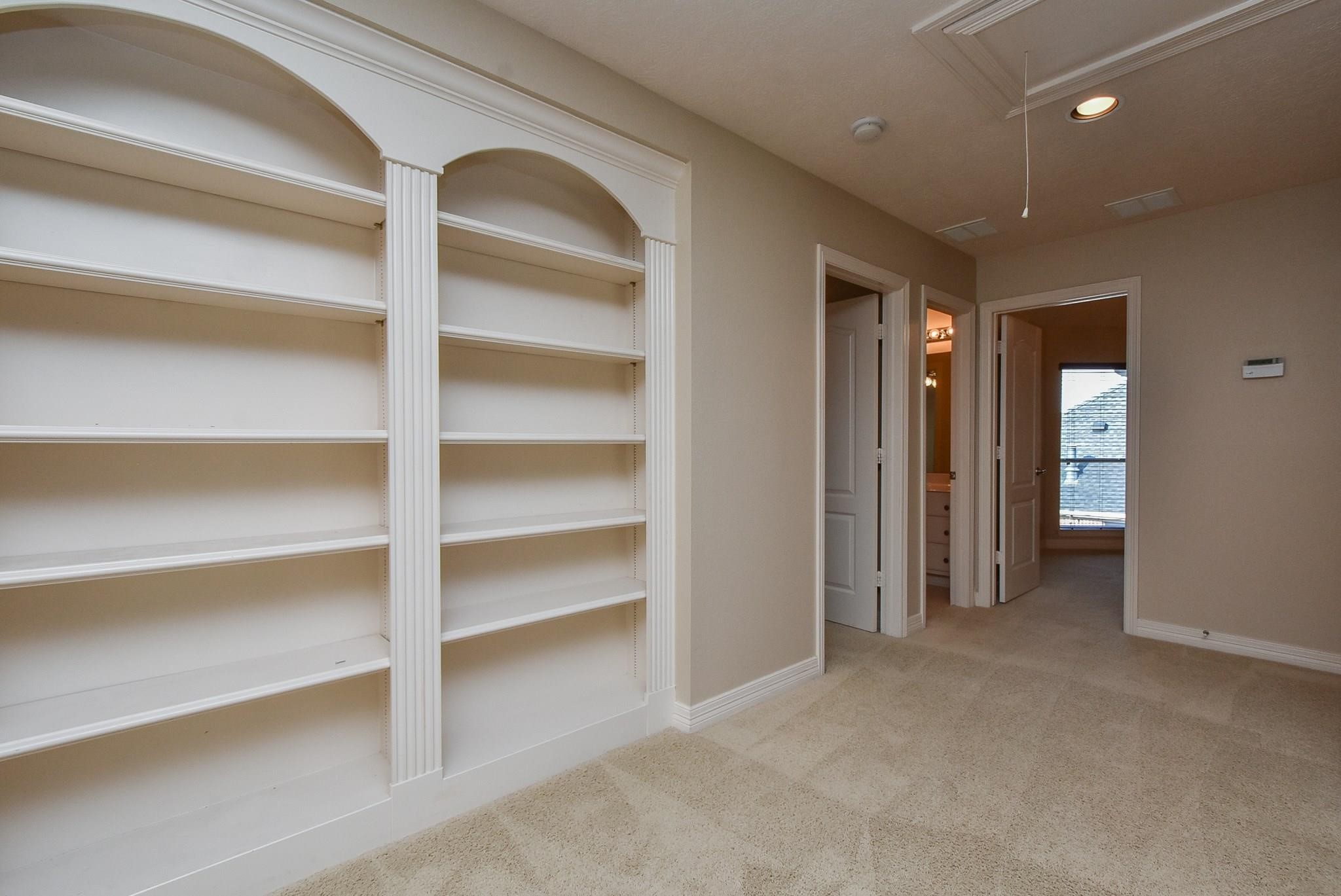 9722 Blue Cruls Way Spring, TX 77379 - Photo 31 of 49 Beautiful wood display shelves at top of the stairs.
