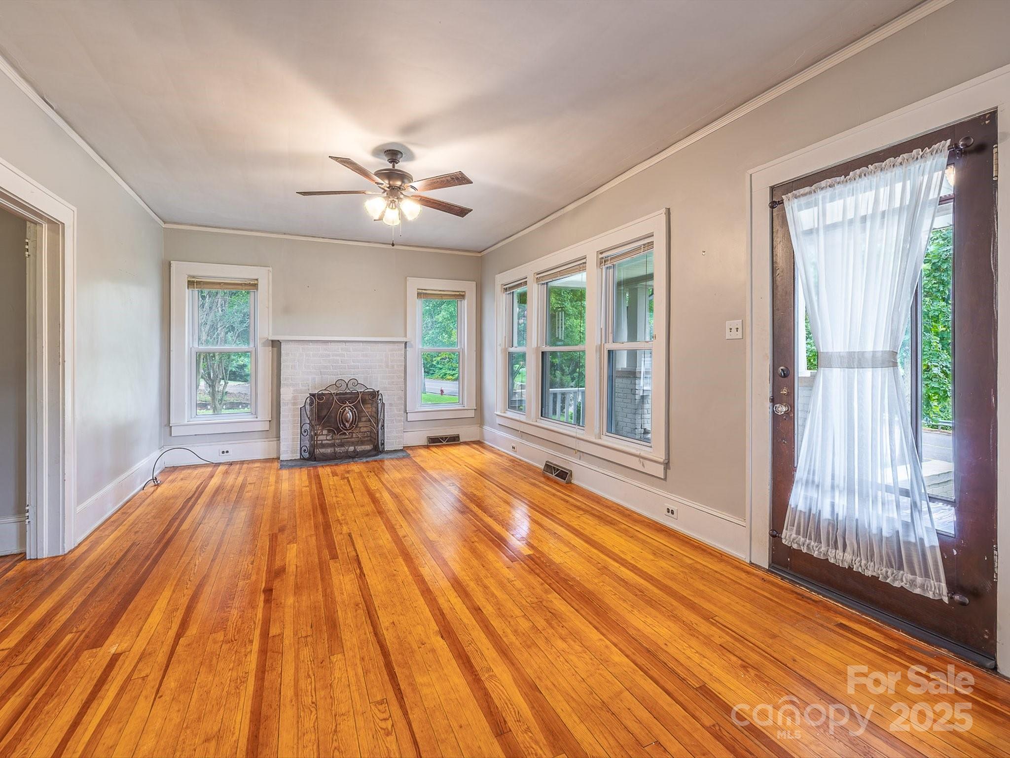 808 West Union Street Morganton, NC 28655 - Photo 16 of 40 a view of empty room with wooden floor and fan