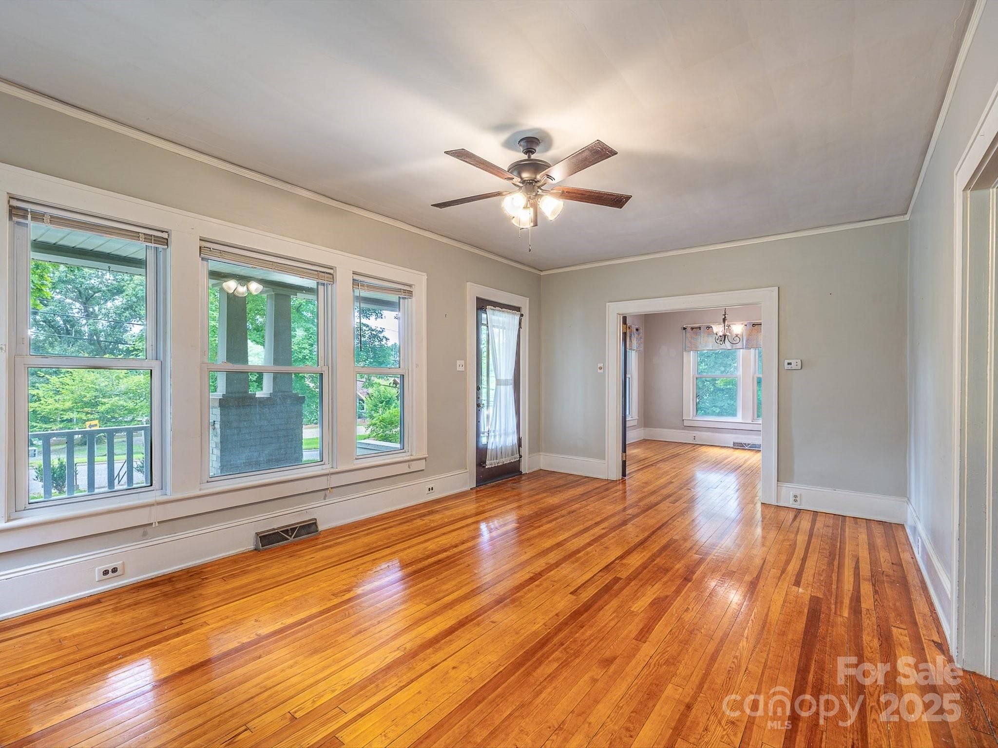 808 West Union Street Morganton, NC 28655 - Photo 17 of 40 a view of an empty room with wooden floor and a window