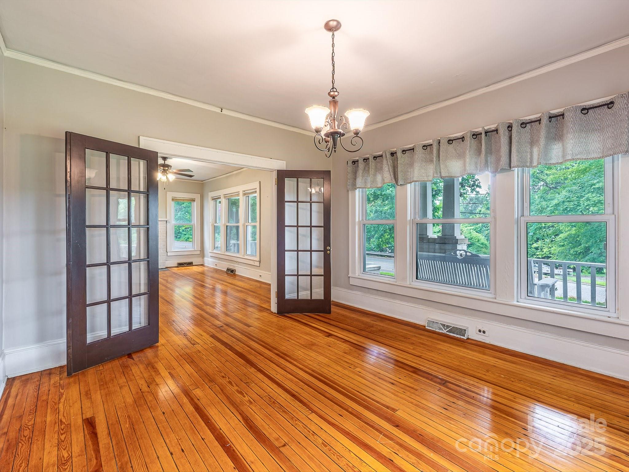 808 West Union Street Morganton, NC 28655 - Photo 18 of 40 a view of empty room with wooden floor and fan