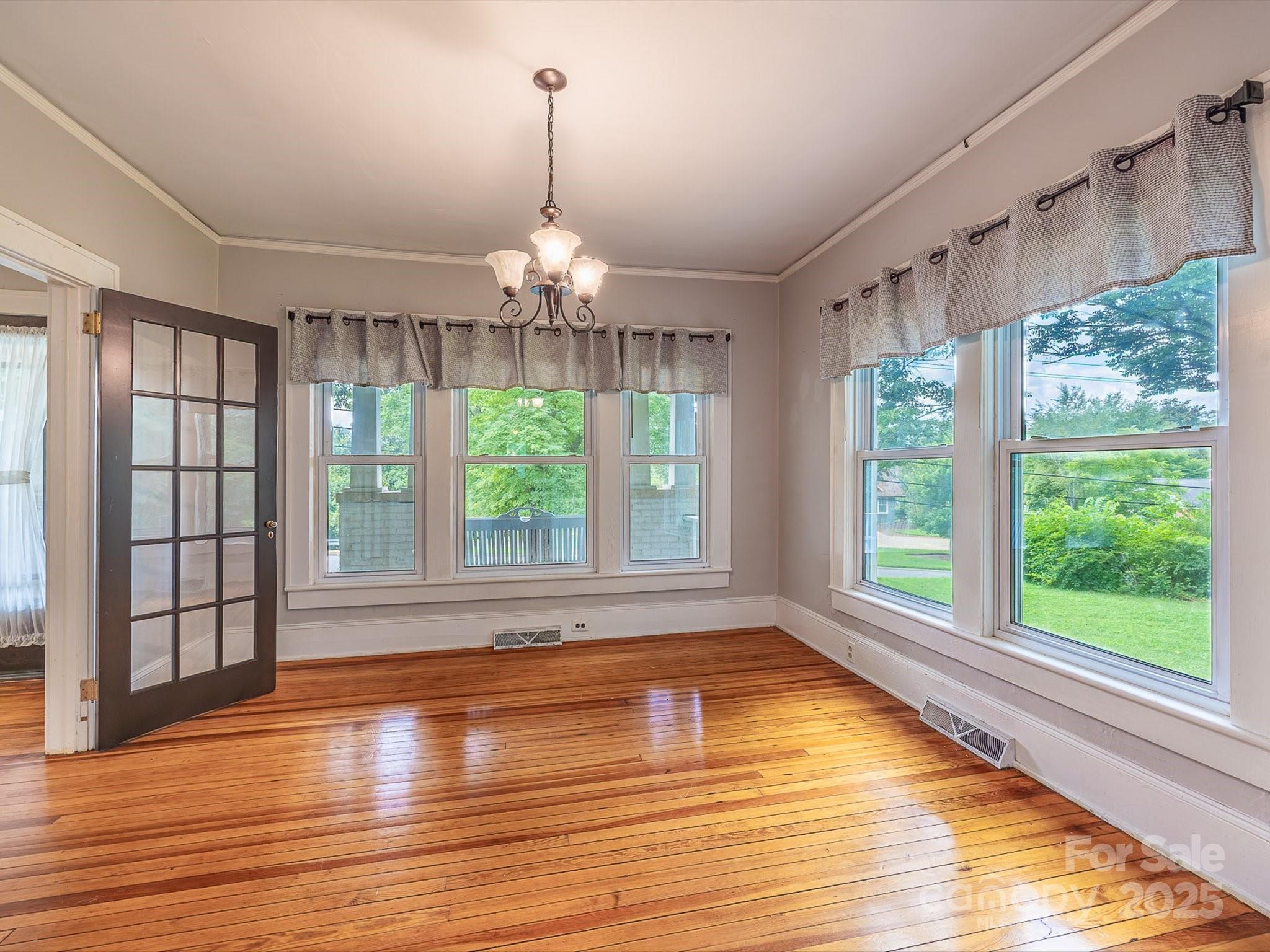 808 West Union Street Morganton, NC 28655 - Photo 19 of 40 a view of an empty room with wooden floor and a window
